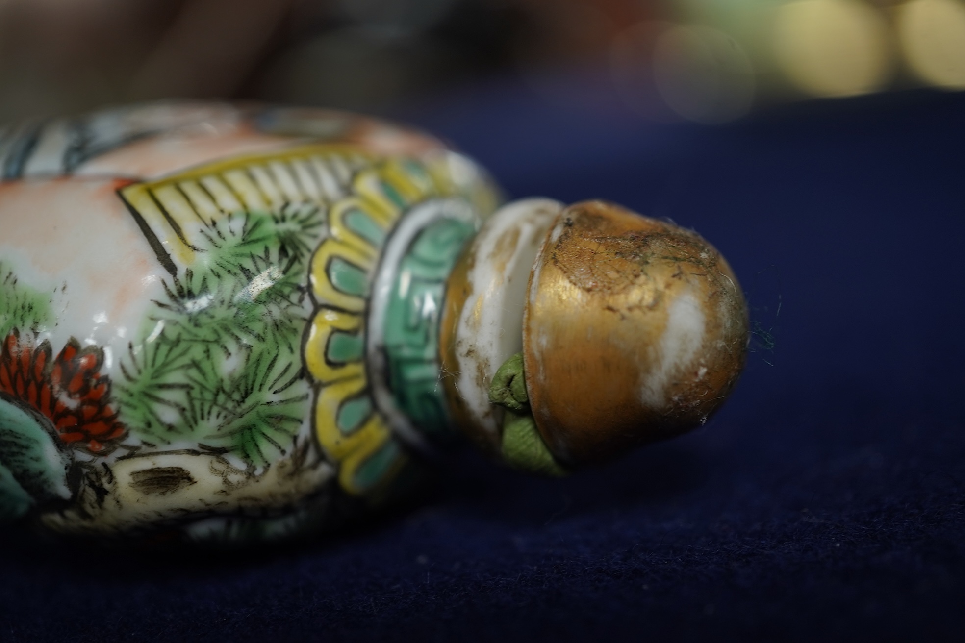 A Chinese enamelled and moulded porcelain erotic subject snuff bottle and stopper, Guangxu mark and possibly of the period, 6.5cm